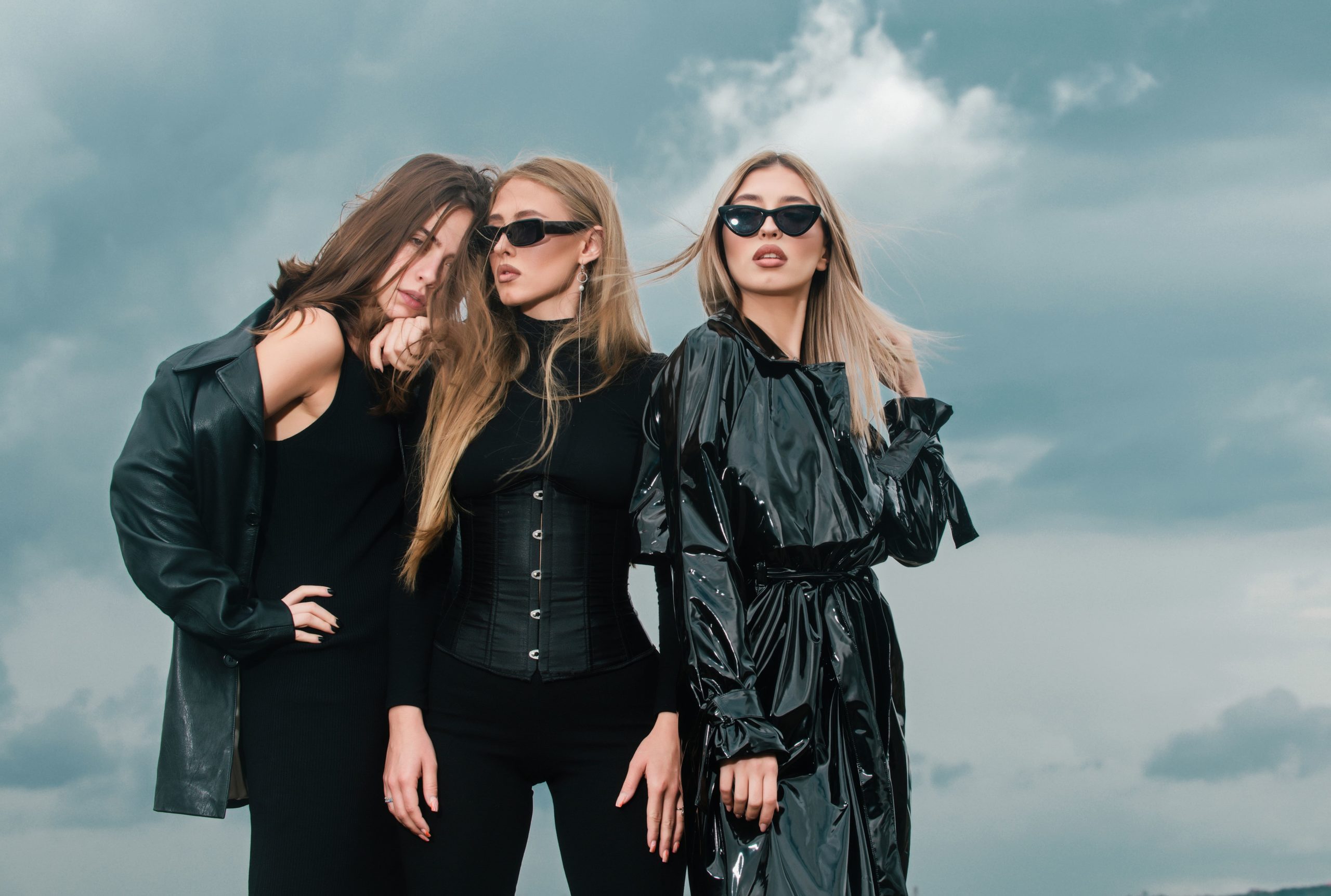 fashion-portrait-group-fashion-models-girls-posing-outdoor-black-style-outfit-against-sky-attract-min